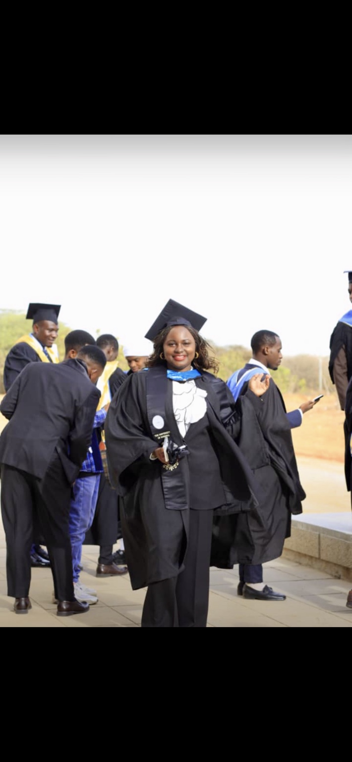 A postgraduate client celebrating graduation in academic dress